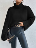 Women's Oversized Waffle Knit Turtleneck Sweater in Black